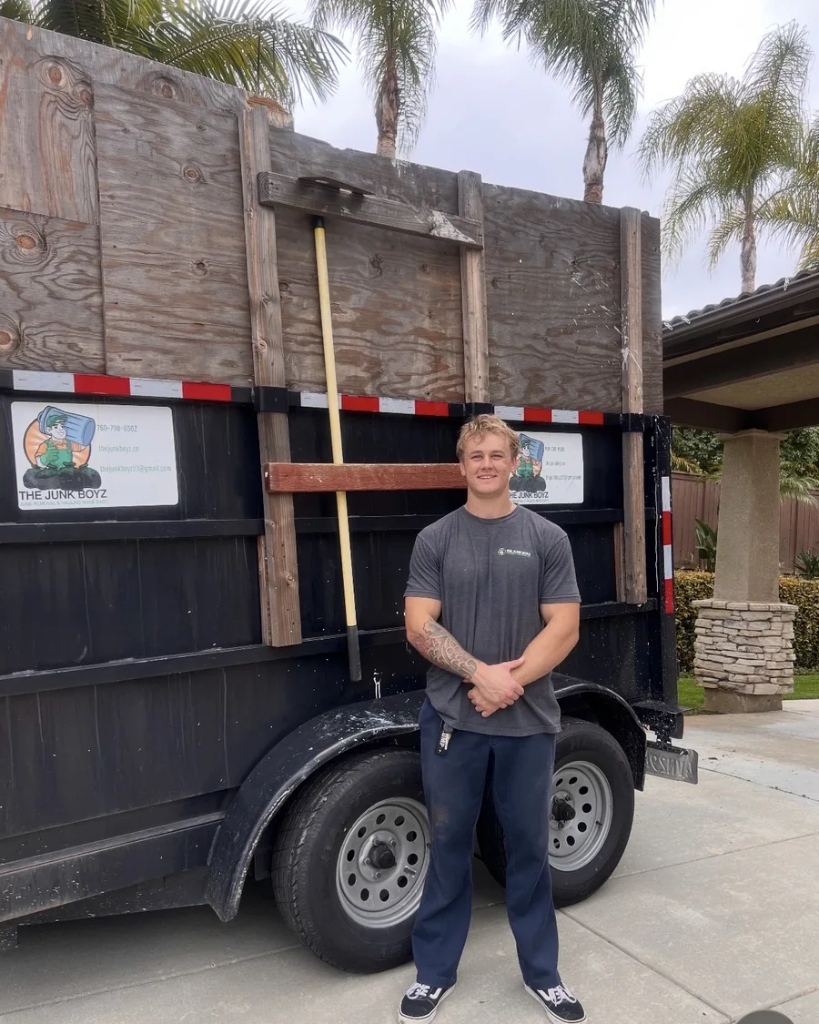 Nick Larson standing in front of a Junk Boyz dump trailer