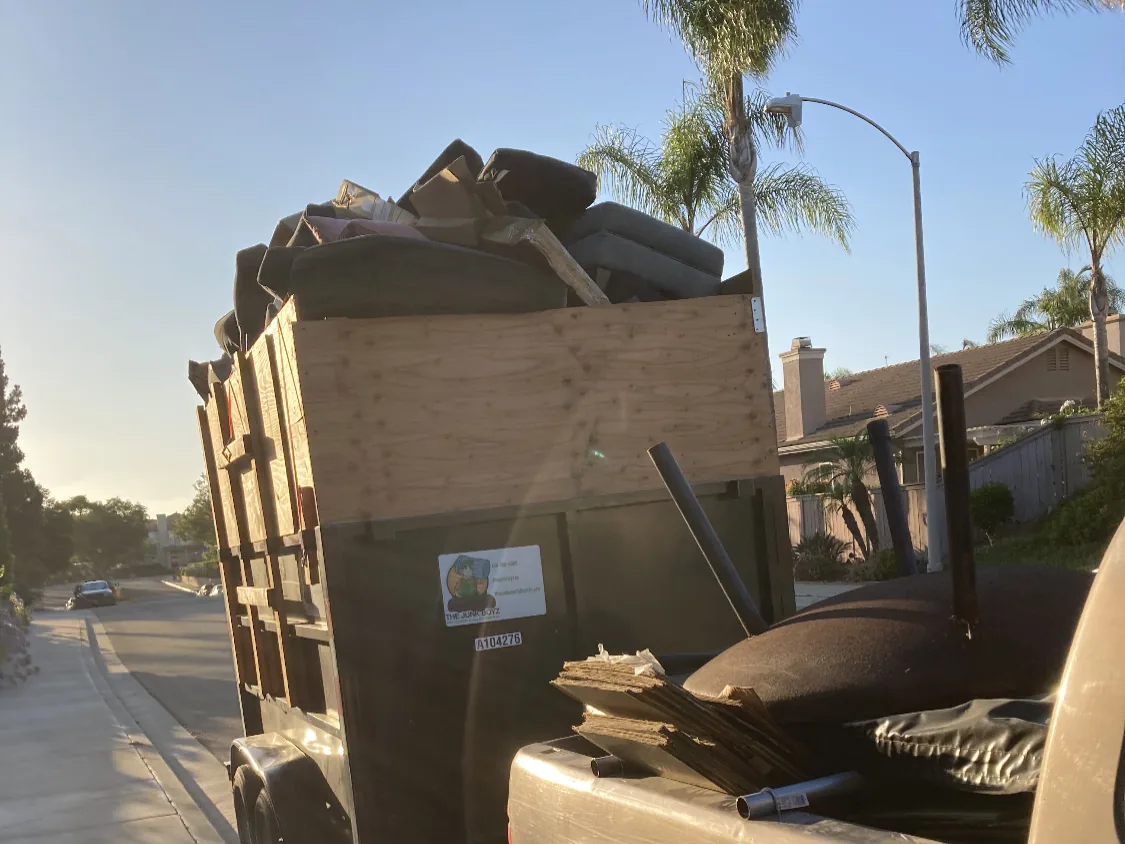 A Junk Boyz trailer loaded to the top on a North County street