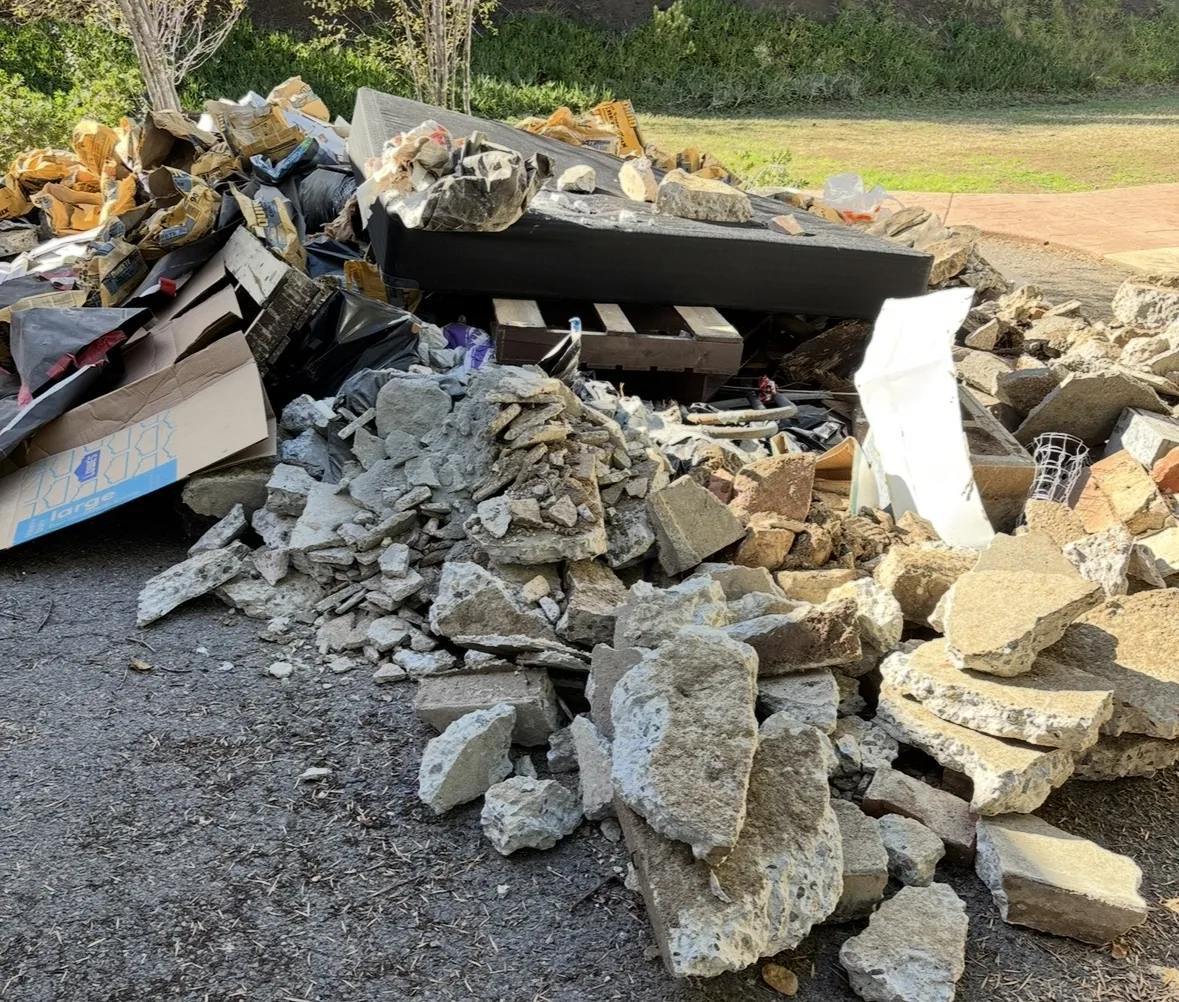 Pile of broken concrete and construction debris on a job site
