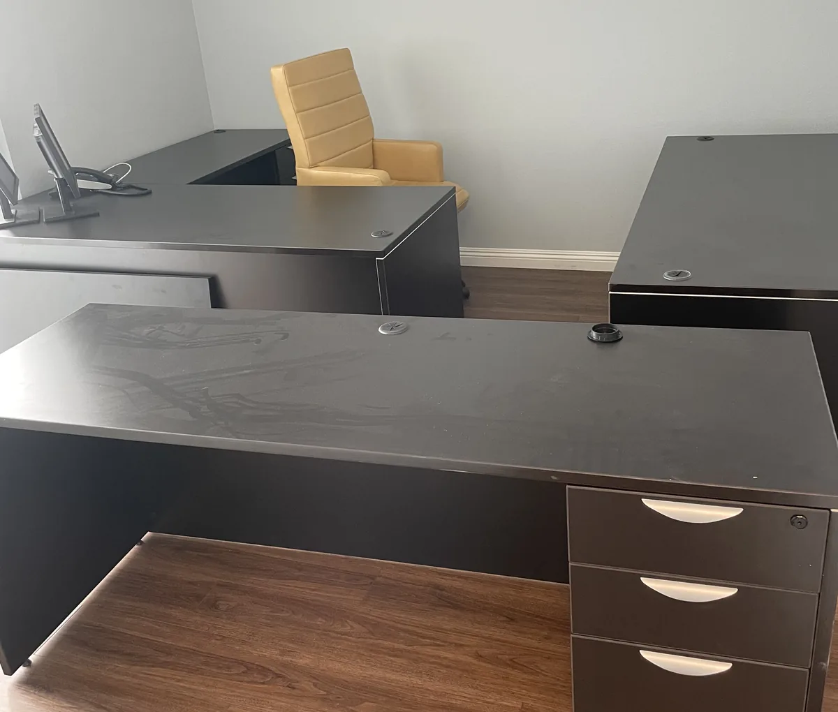Old office desks and a chair left in an empty office