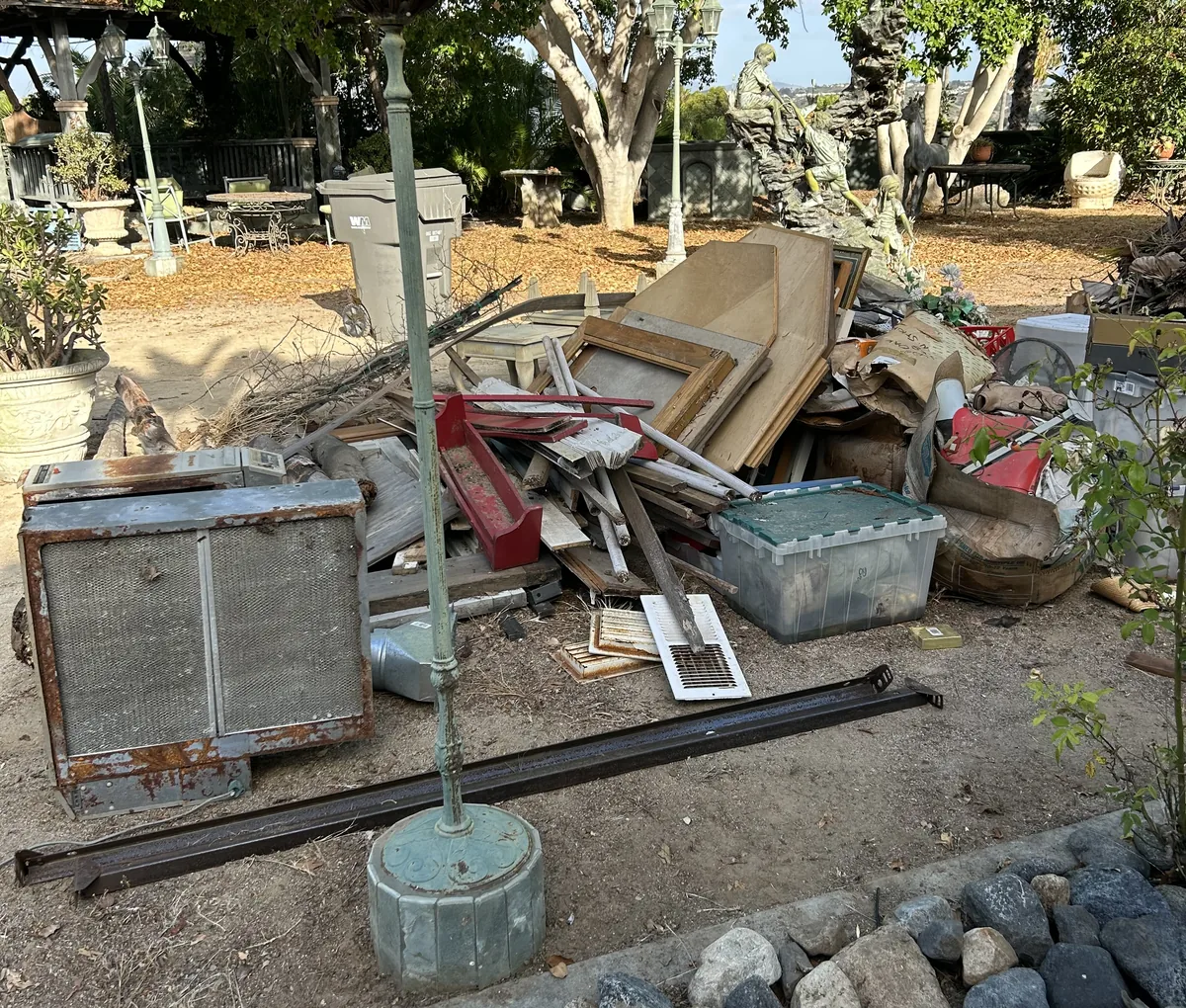 Pile of old furniture and junk in a backyard, ready for a cleanout