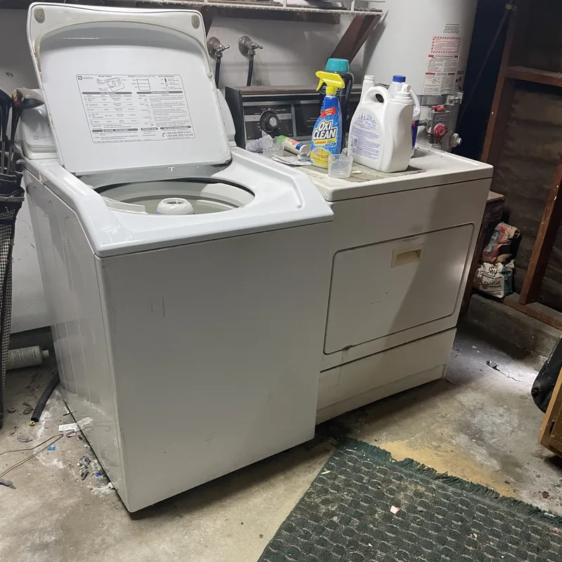 Old washer and dryer set sitting in a garage